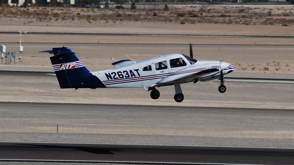 Piper Seminole twin engine aircraft taking off on a hot desert day