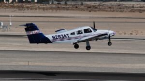 Piper Seminole twin engine aircraft taking off on a hot desert day